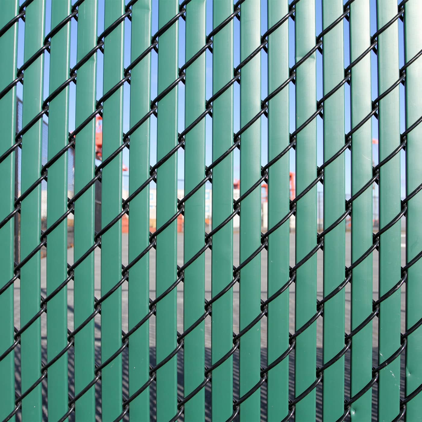 Eads dumpster enclosures made with chain link and privacy slats.