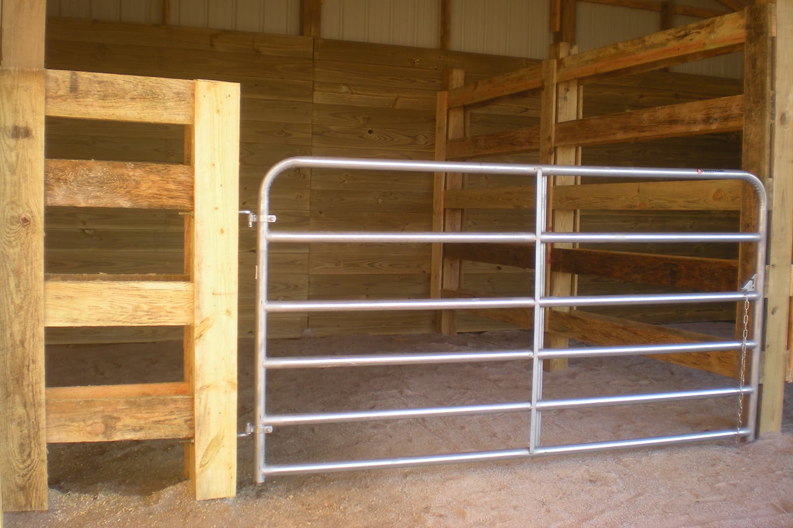 A wood farm fence with a metal gate