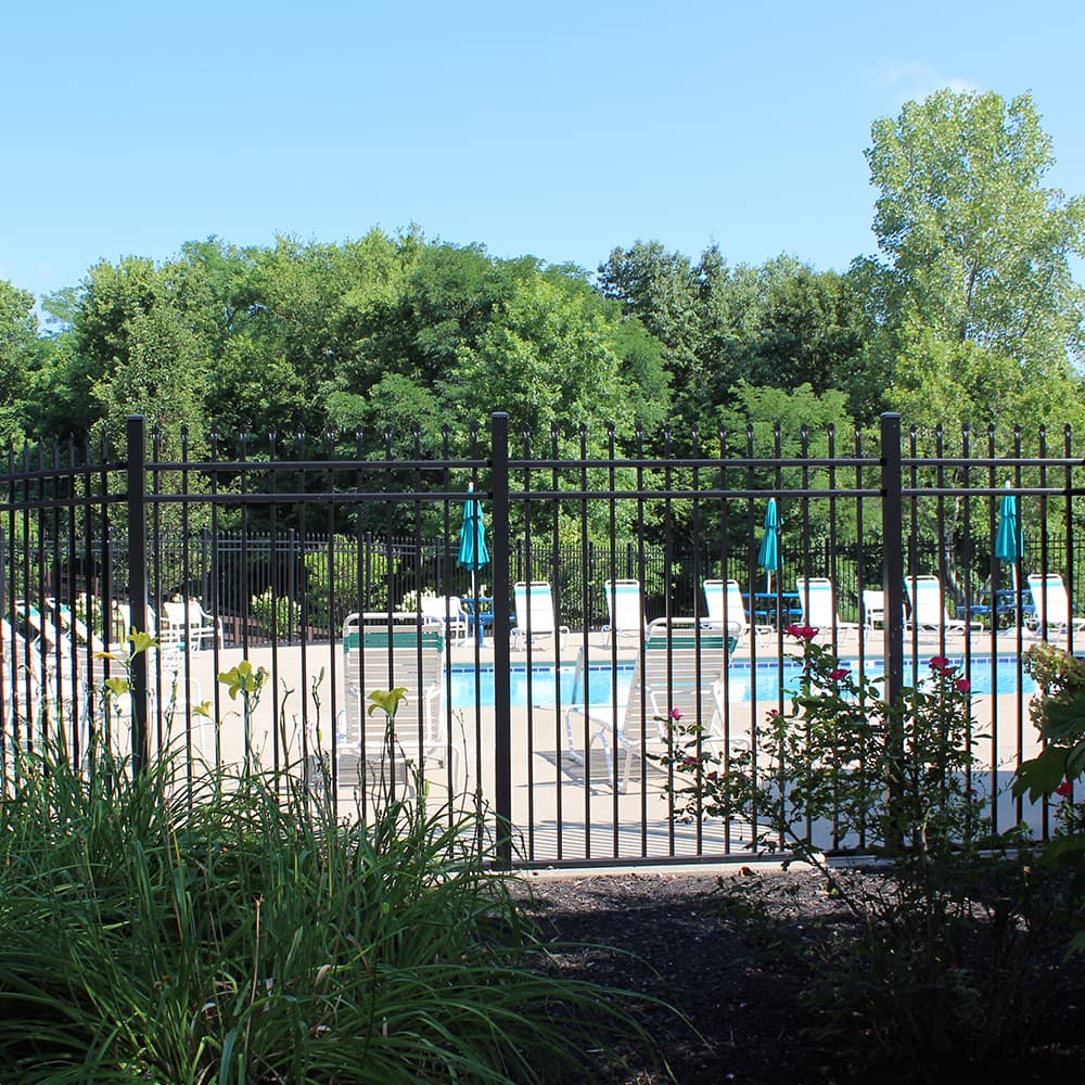 A pool that has a black fence