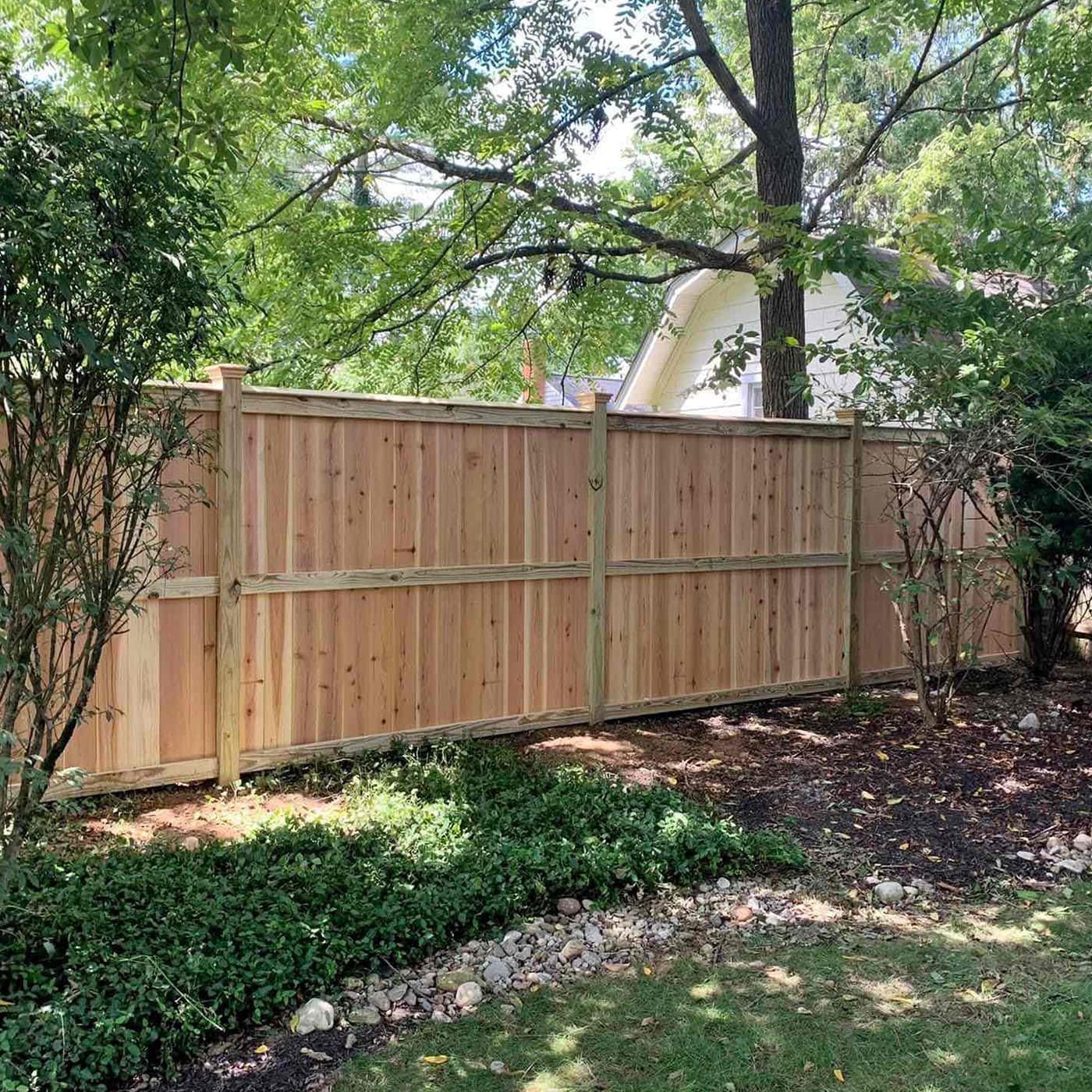A wood privacy fence separating two yards