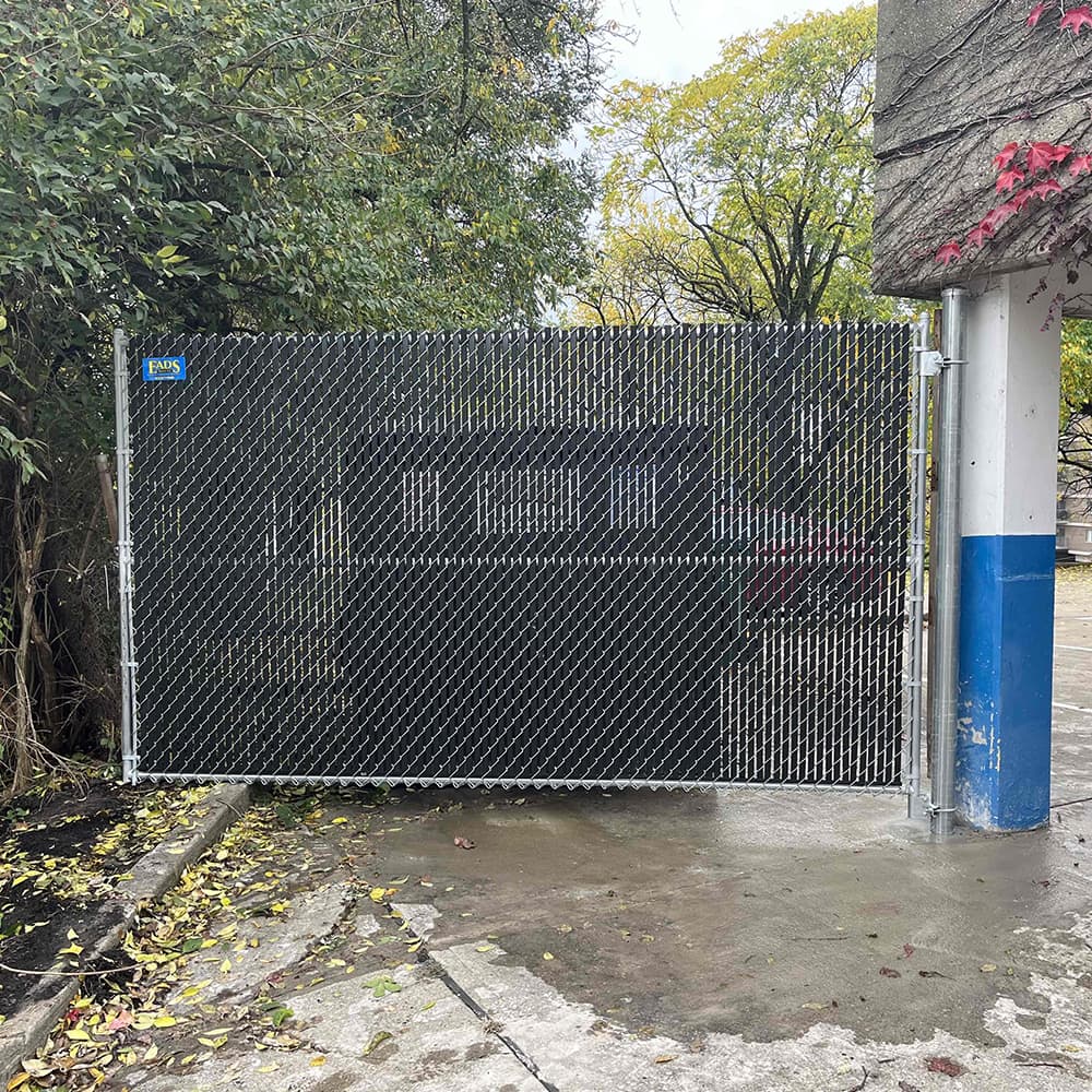 A chain link fence around a dumpster