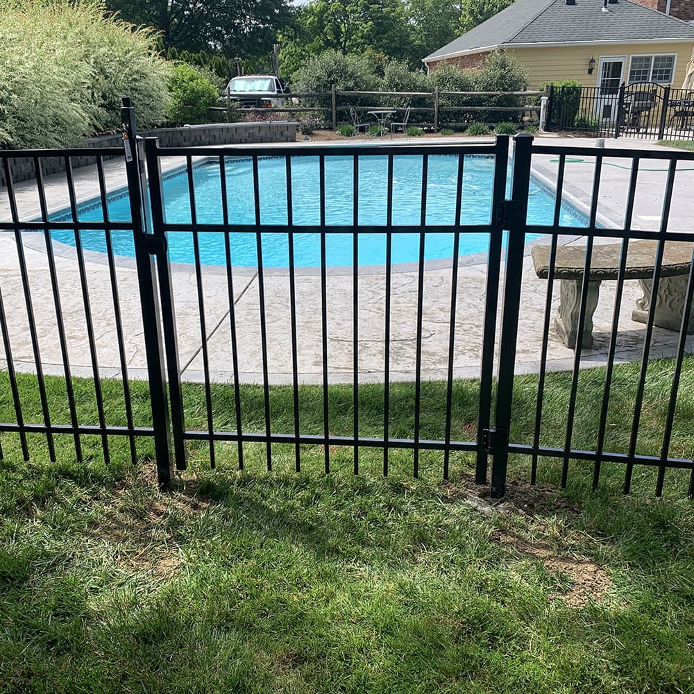 A black metal gate around a pool