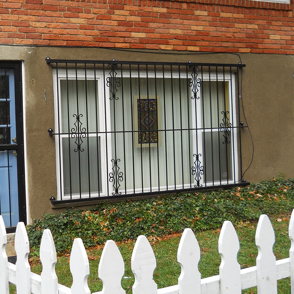 Metal fabrication security gate in front of a window