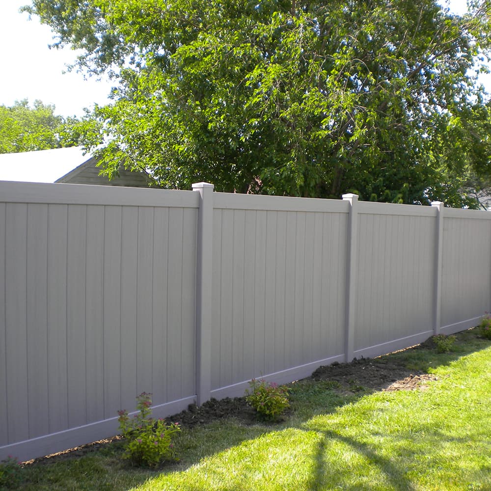A white vinyl privacy fence