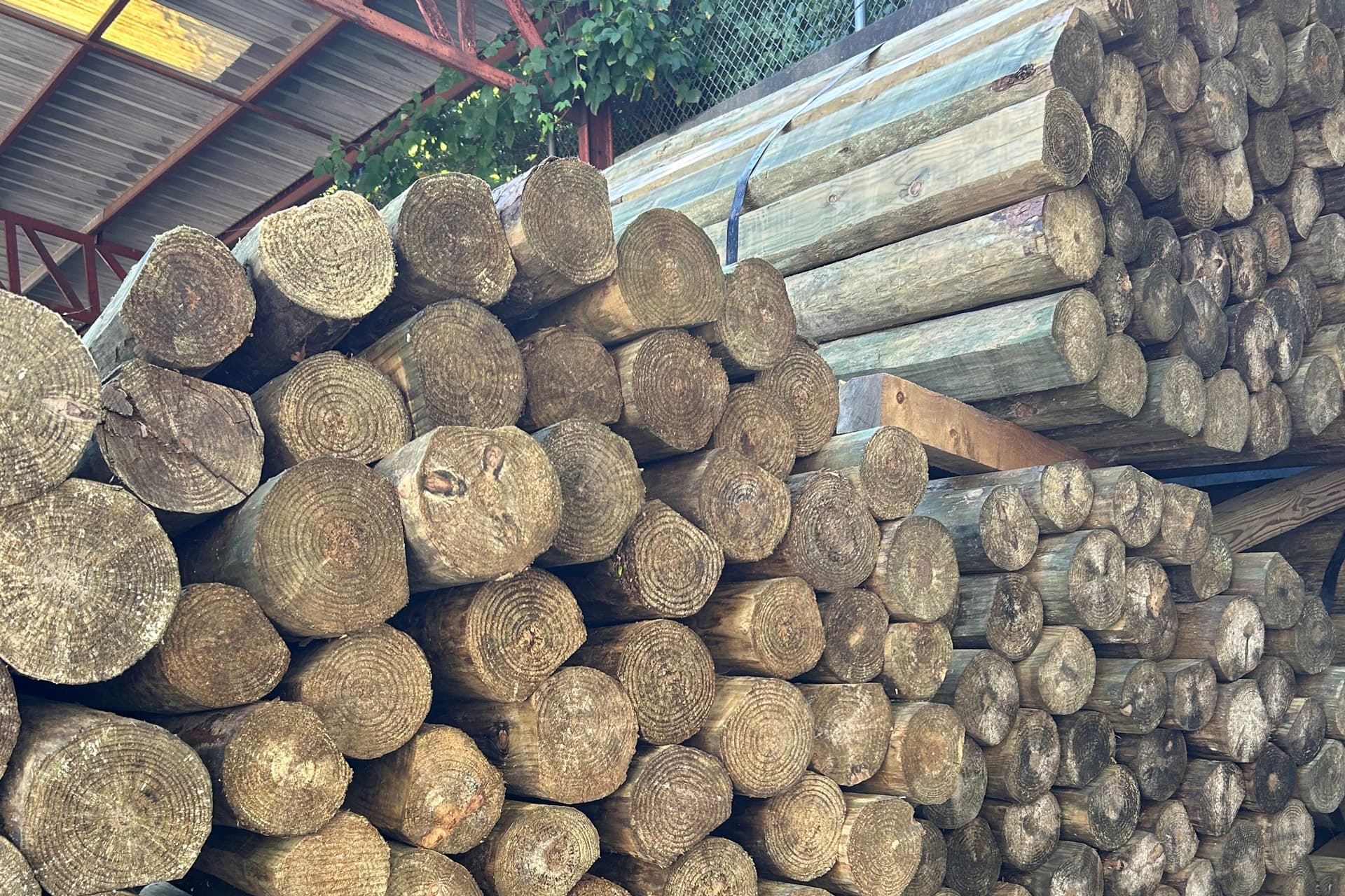 Large stacks of fence posts for Eads Fence Co. farm fences