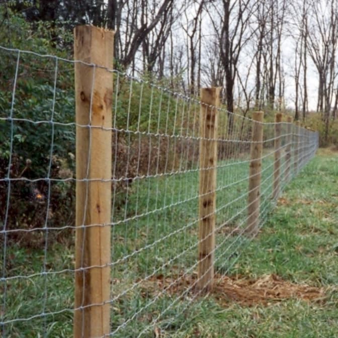 An Eads Fence Co. farm fence surrounding an area of grassy hills
